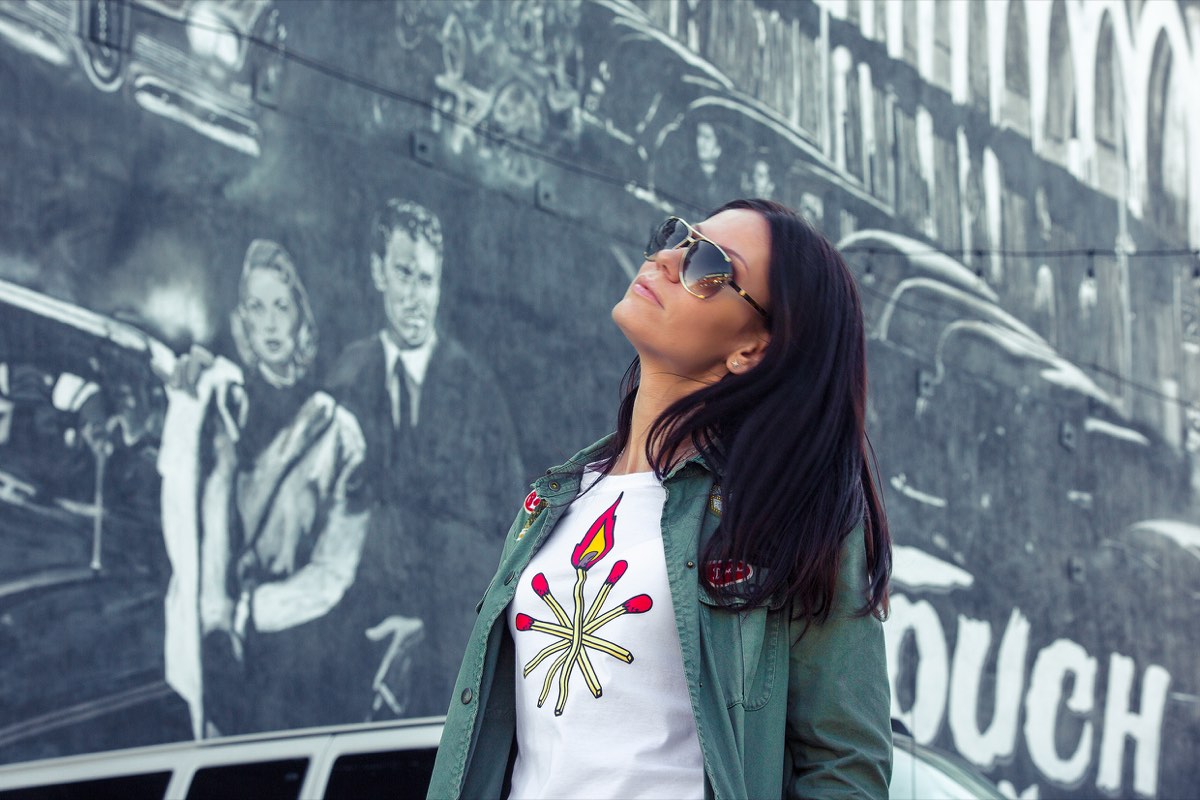 Guest by a classic Hollywood mural on a full-day Los Angeles tour