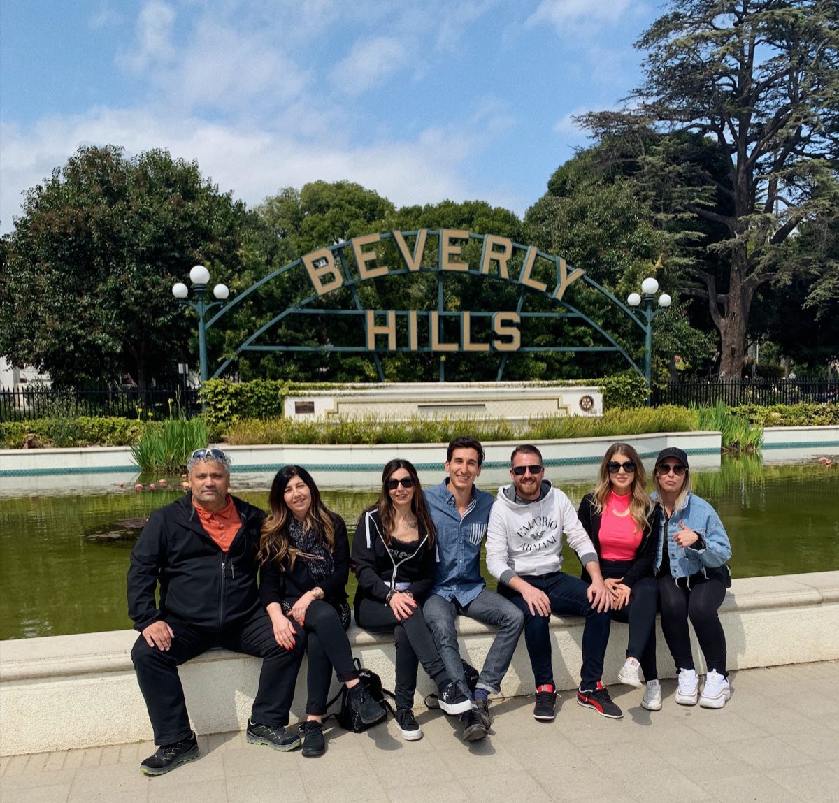 Group of guests at the Beverly Hills sign on a full-day LA tour