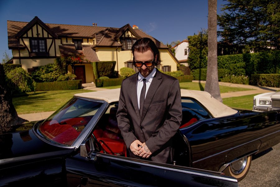 The black 1970 Cadillac DeVille parked outside a Tudor-style house in Los Angeles