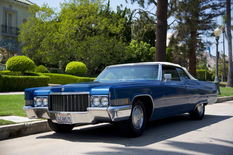 Blue 1970 Cadillac DeVille convertible parked on a Los Angeles street