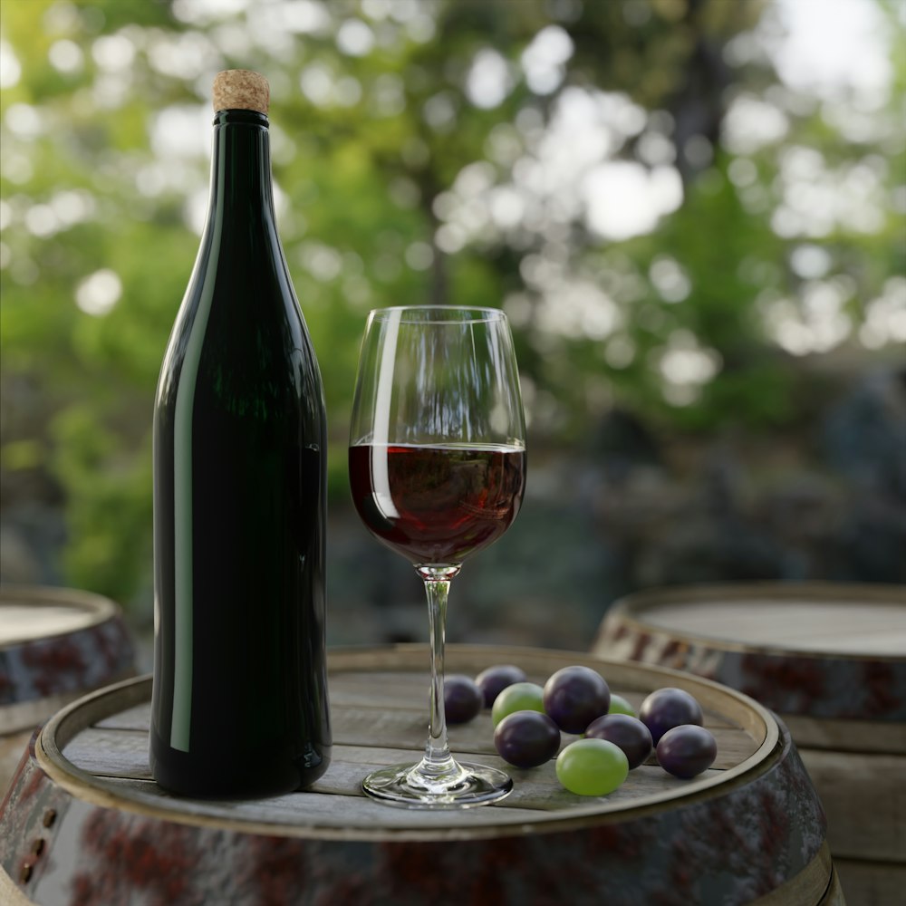 A bottle of wine and grapes on a table