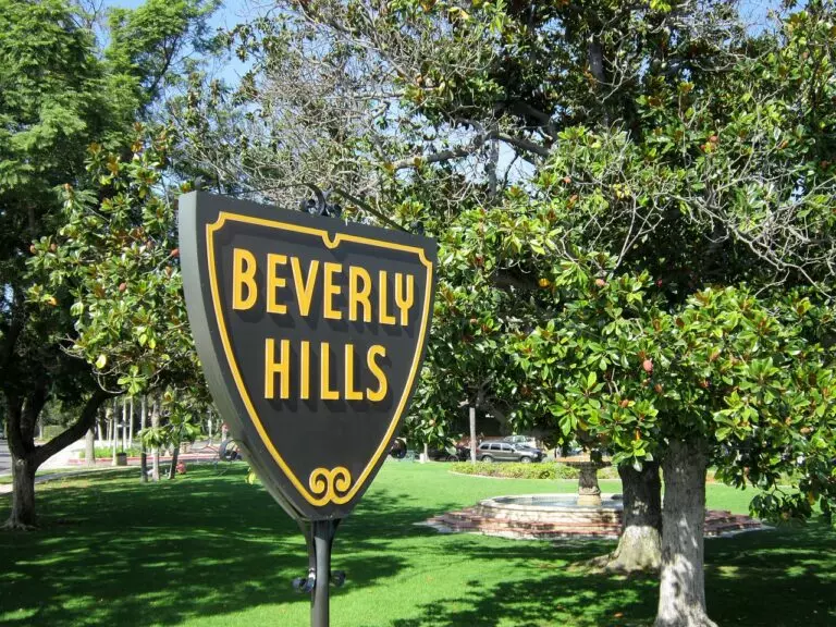The Beverly Hills shield sign in a park with green lawns