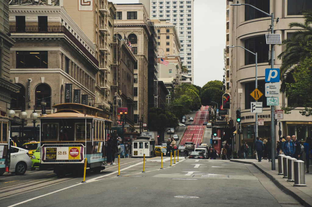 A cable car climbing a steep downtown street in San Francisco