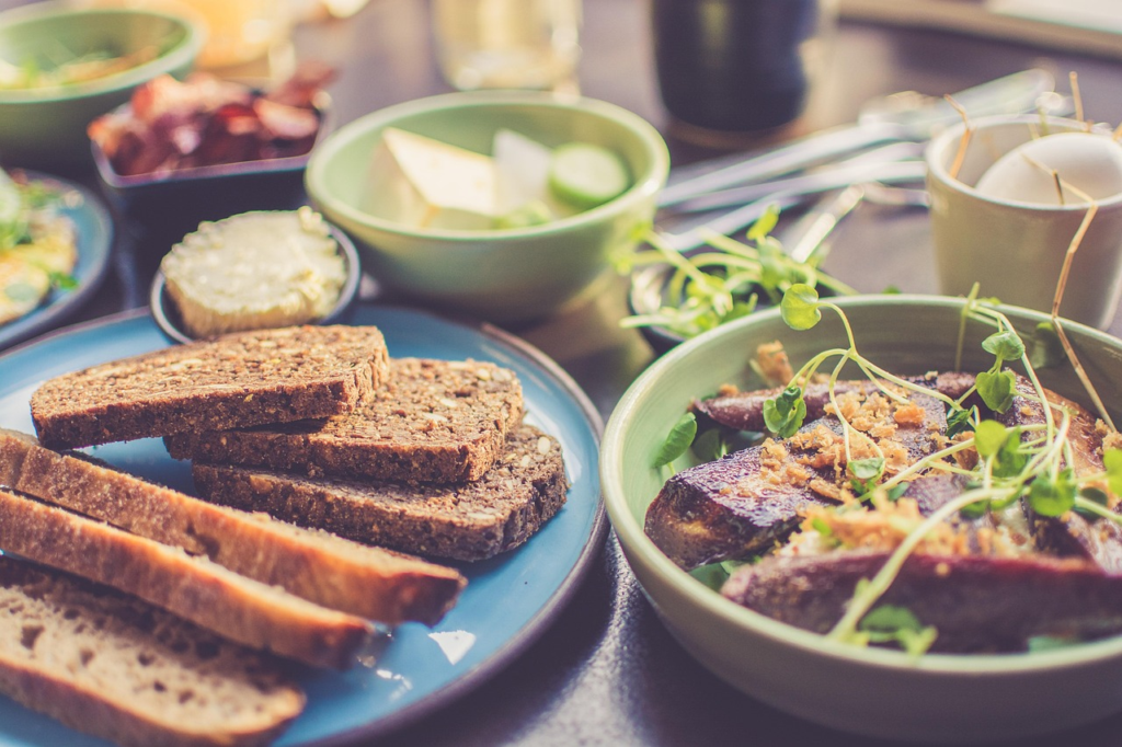 Sliced rye bread and small bowls of food on a restaurant table