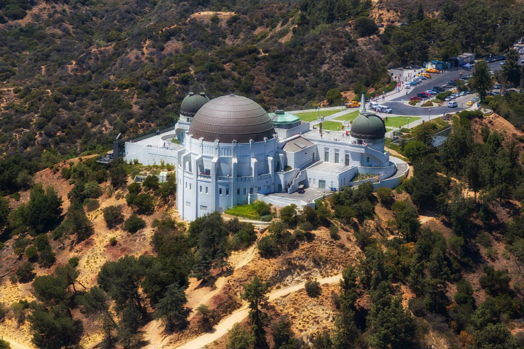 Griffith Observatory on a wooded hillside, seen from above